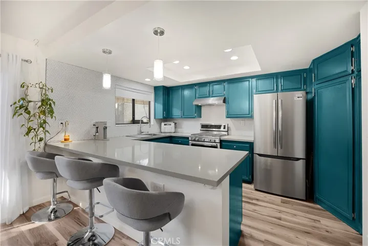 Kitchen with breakfast bar, modern appliances.