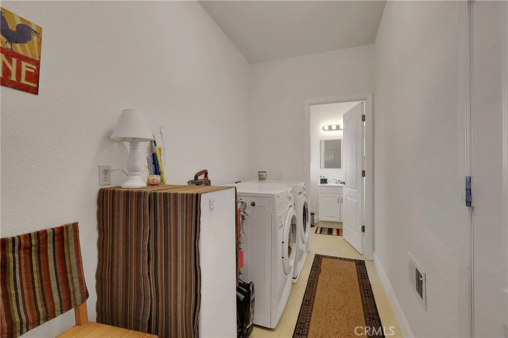 Main floor laundry and half bath, stairs go downstairs to 2nd level. And door to 4 car garage.