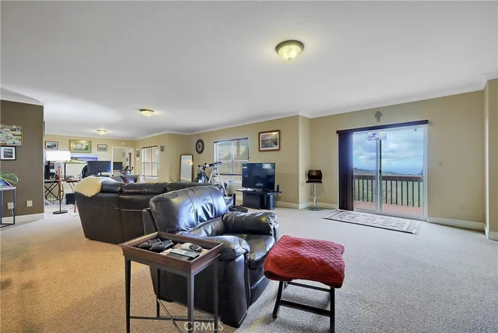 Down stairs with sliding glass doors to covered decks.