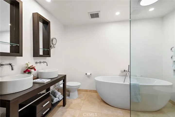 Upgraded bath with soaking tub, large shower, heated towel rack and gorgeous builtin's