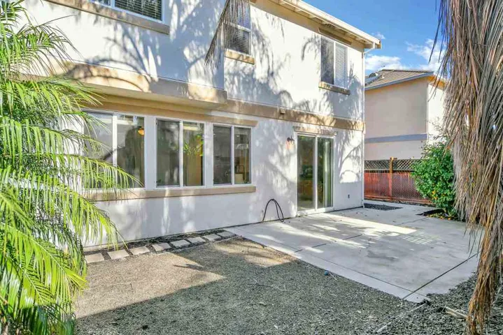Rear view of property with stucco siding and a patio