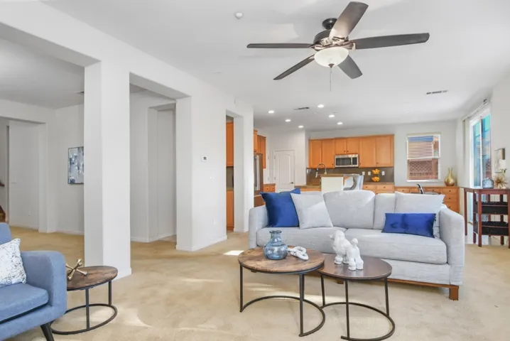 Living room featuring light carpet, recessed lighting, and a ceiling fan