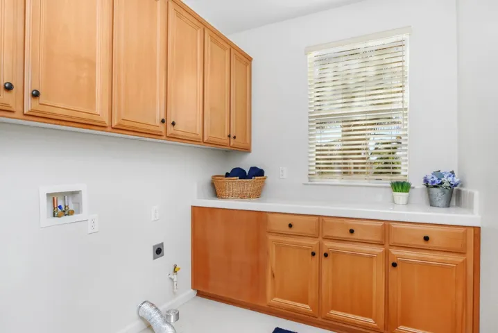 Laundry room featuring cabinet space, electric dryer hookup, and hookup for a washing machine