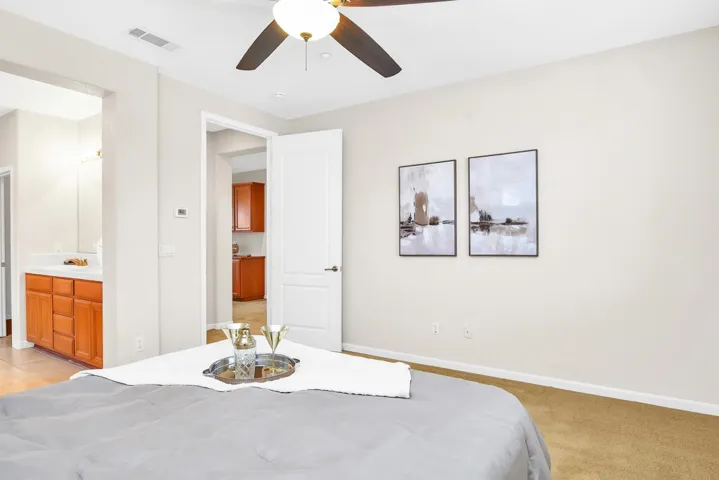 Bedroom with a ceiling fan and ensuite bathroom