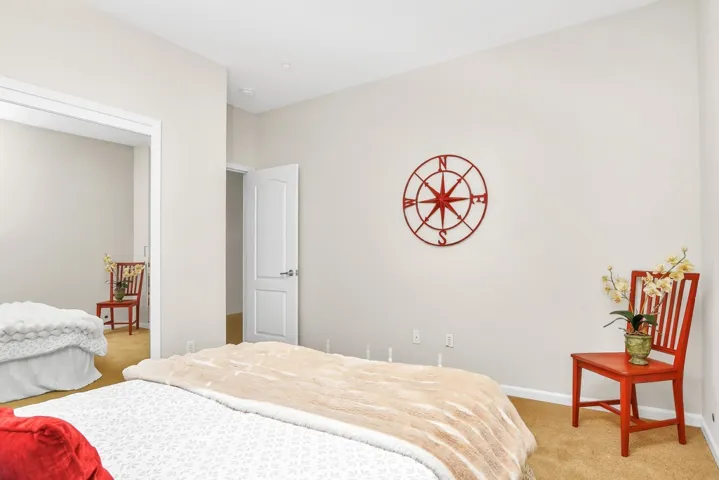 Bedroom with light carpet and baseboards