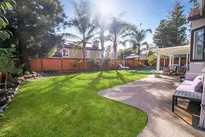 Fenced backyard featuring a patio, an outdoor hangout area, and a pergola