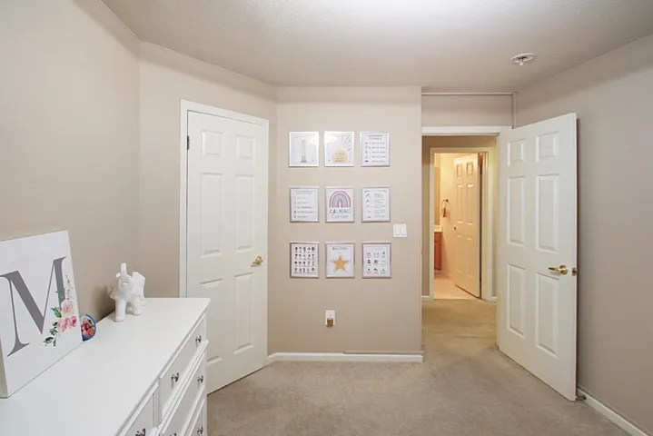 Home office featuring light carpet and a textured ceiling