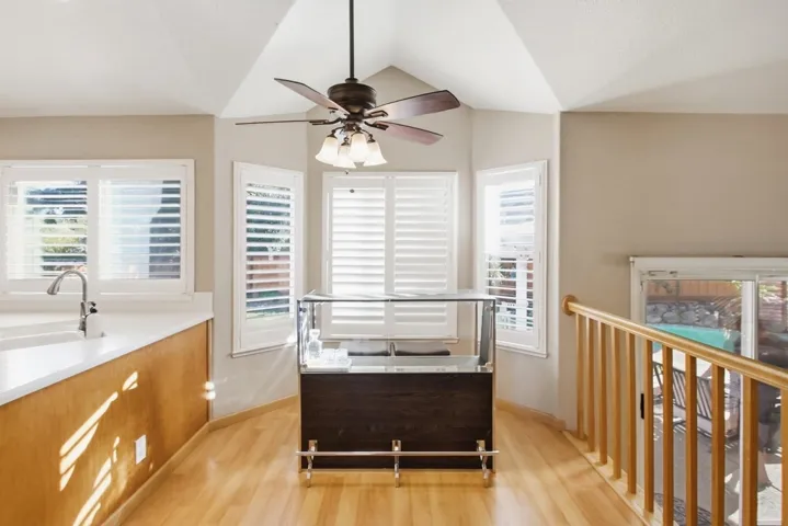 Office featuring a ceiling fan, light wood-style floors, plenty of natural light, and lofted ceiling