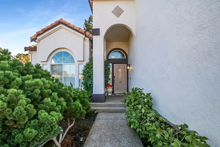 Entrance to property with stucco siding