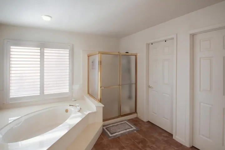 Bathroom with a garden tub and a stall shower