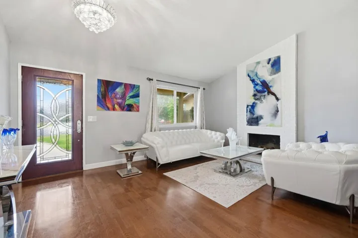 Living Room with Cozy fireplace and wood flooring