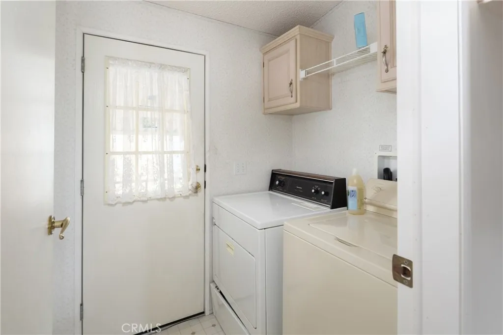 Laundry area right off the stairway from the carport into the house.