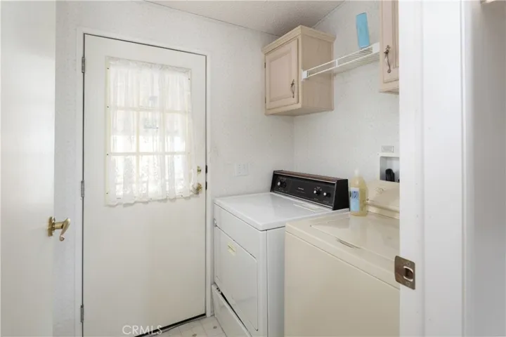 Laundry area right off the stairway from the carport into the house.