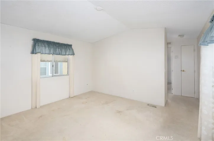 Notice the open floor plan of the kitchen/dining room and living room.