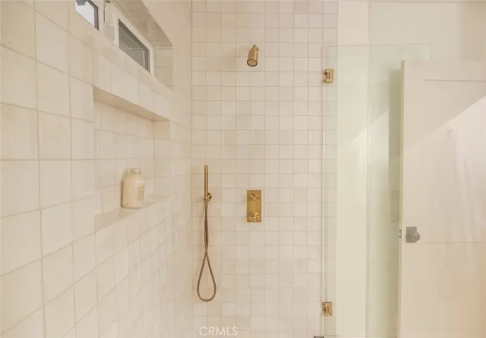 Guest bath en-suite features Phylrich brass fixtures.