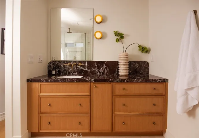 Custom millwork with marble counters and custom accent lighting.