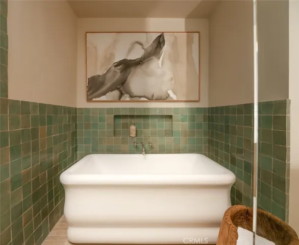 Large soaking tub with zellige wrapped niche.