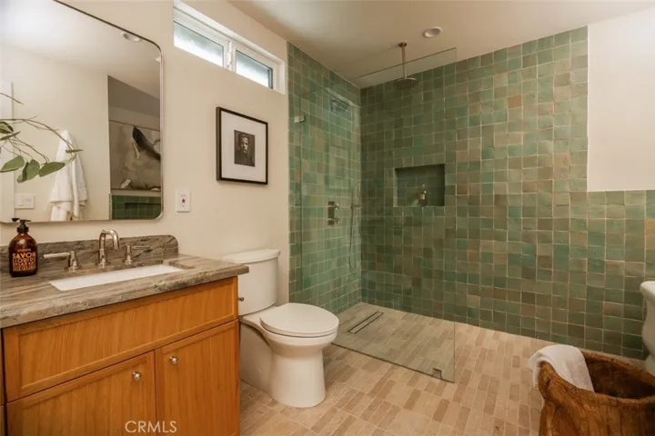 The counters pair perfectly with the tumbled limestone floors which flow seamlessly into the curbless shower.