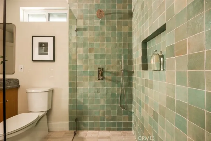 Zellige tile wrapped floor to ceiling with custom thermostatic 3 feature shower set.