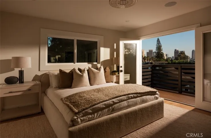 Primary bedroom features balcony, overlooking the backyard with sweeping views of downtown.