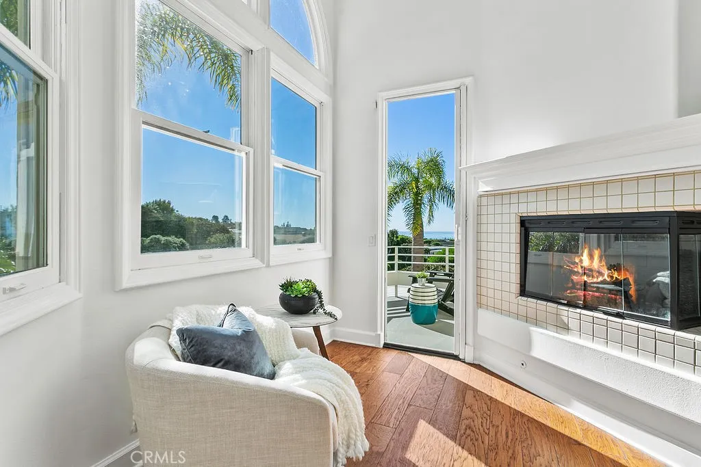 Your primary bedroom sitting area faces the corner fireplace and is next to the door to your secluded ocean view balcony. Fire in fireplace is virtually created.
