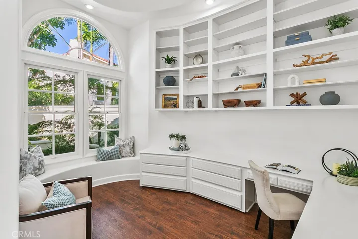 Sun lit windows and tall ceilings help make this downstairs office a comfortable place to work.