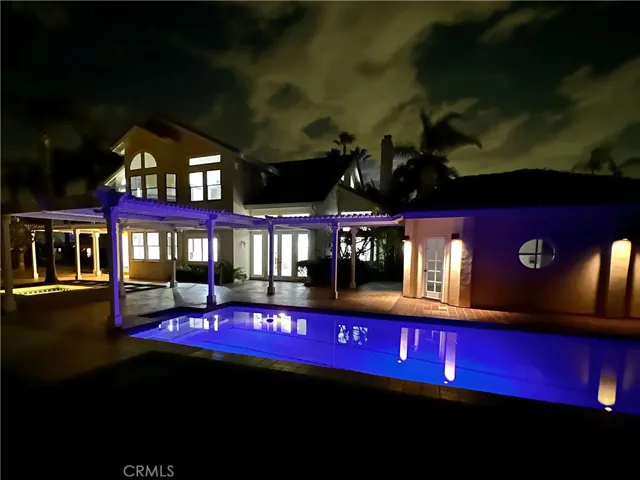 Night view of pool with floating lights.
