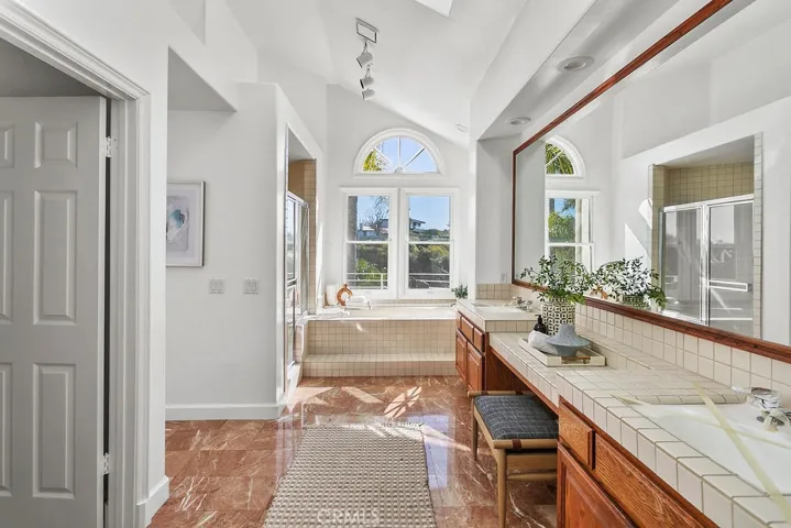 View primary bathroom has soaking tub and walk in shower