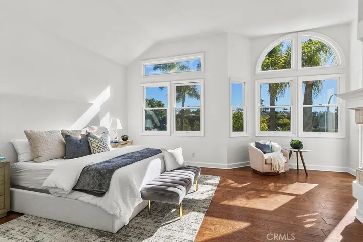 Your primary suite welcomes your view with tall windows and vaulted ceiling.