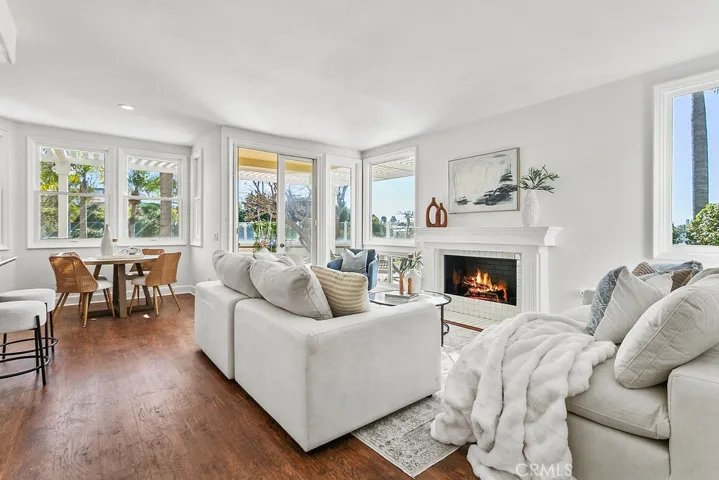 Family room is adjacent to breakfast.area, has a cozy fireplace and ocean view windows as well as access to the yards. Fire in fireplace is vitually created.