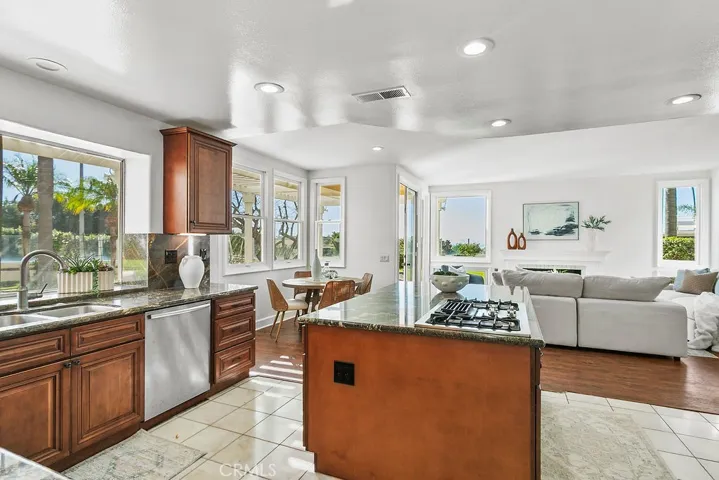 View from kitchen to outdoors and family room.  Note that cooktop is down vented so the openness and view are not obtructed.