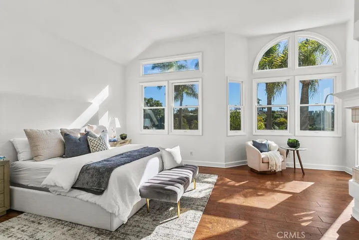 Your primary suite welcomes your view with tall windows and vaulted ceiling.