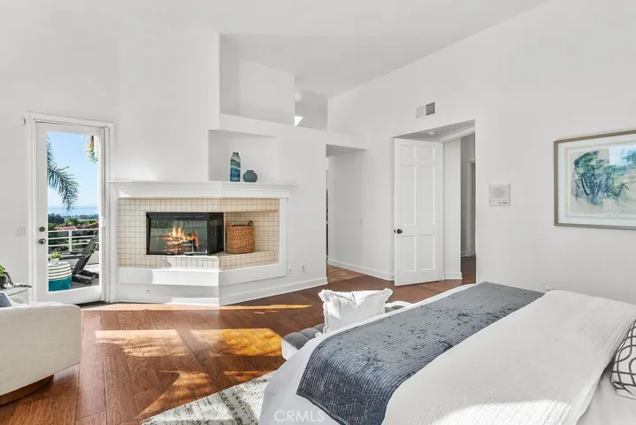 Corner fireplace and access to ocean view balcony, plus a sitting area in your ensuite primary bedroom. Fire in fireplace is virtually created.