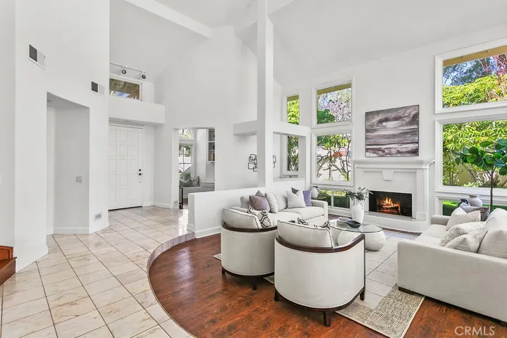 View of front entry from the living room.  Fire in fireplace virtually created.