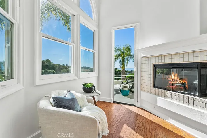 Your primary bedroom sitting area faces the corner fireplace and is next to the door to your secluded ocean view balcony. Fire in fireplace is virtually created.