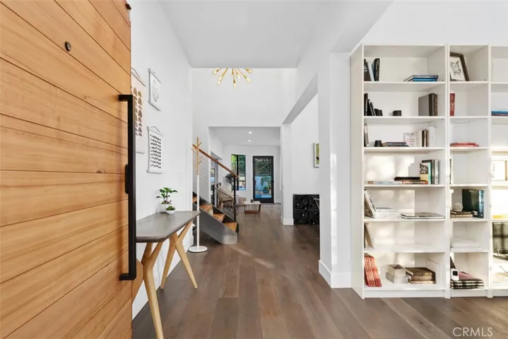 Designer front door opens to foyer and library