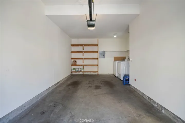 Private 1-car garage with laundry area and ample storage.