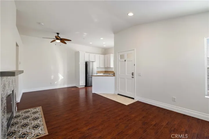 Living room has high ceilings, recessed lights, mosaic tiled fireplace and hardwood​​‌​​​​‌​​‌‌​​‌​​​‌‌​​​‌​​‌‌​​‌‌​​‌‌​​​​ floors.