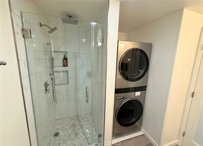 Primary bathroom with updated shower and brand new washer and dryer