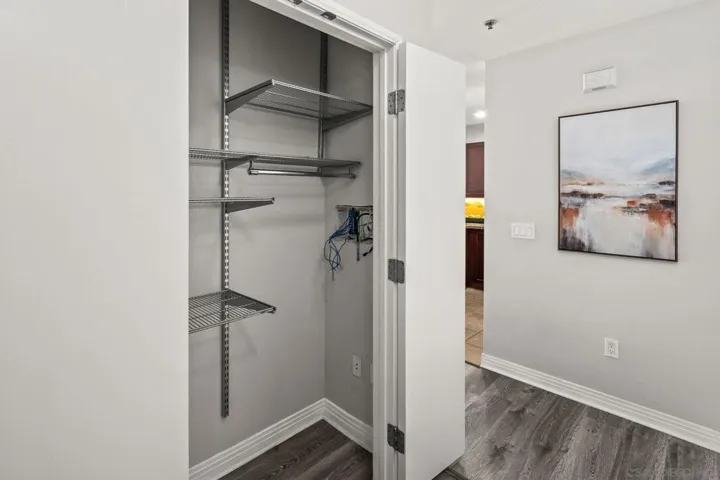 Hall closet/storage. Shelving by Elfa Container Store