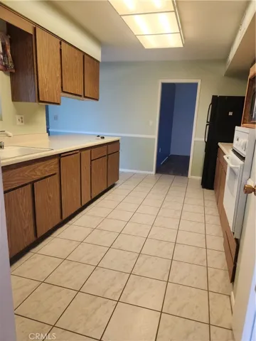Long kitchen from entryway to formal dining room