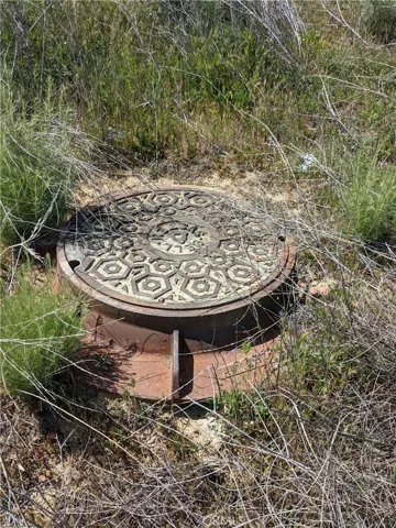 Reference only - The manhole is on the dirt road on the way in, but not on the property itself.