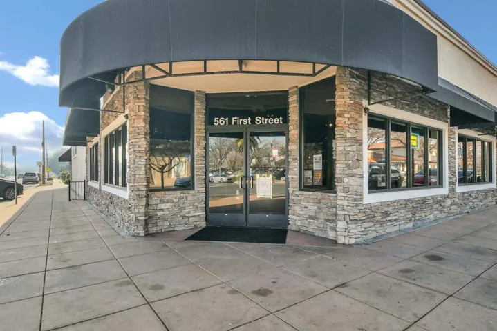 View of exterior entry featuring french doors and stone siding