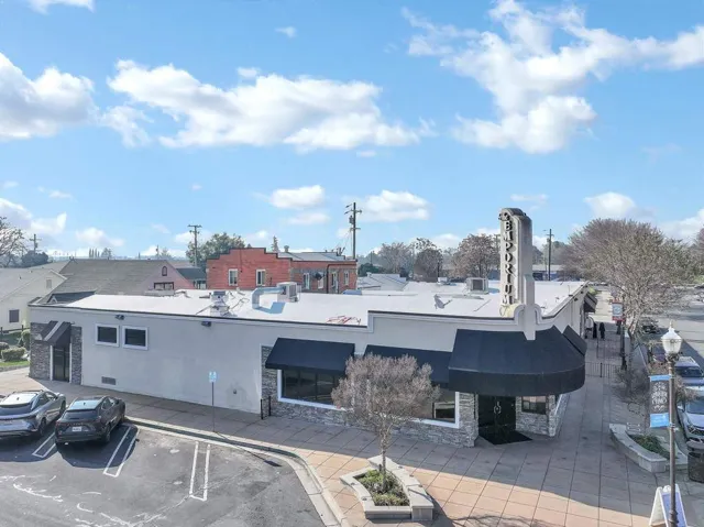 View of property featuring uncovered parking