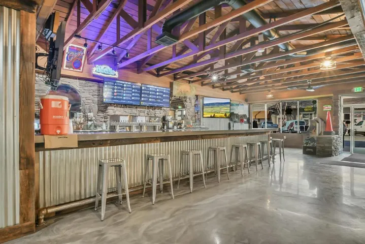 Indoor dry bar featuring wooden ceiling