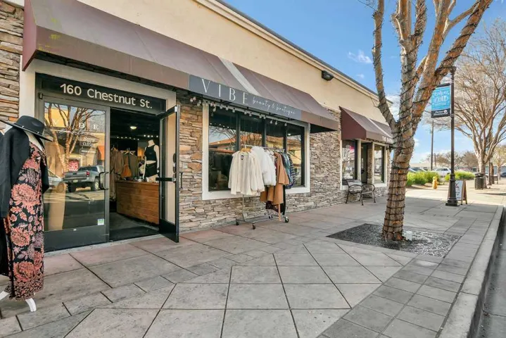 Property entrance with stone siding and stucco siding