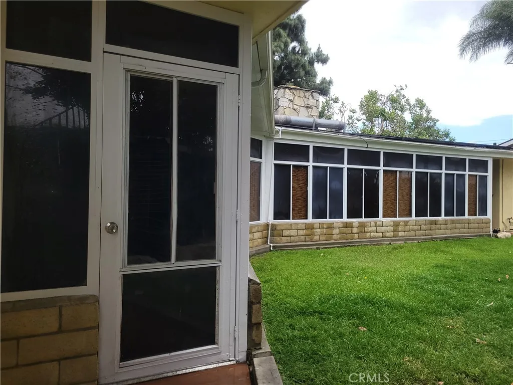 Enclosed patio has multiple doors