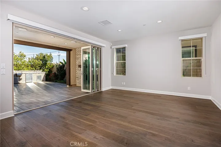 Dining area opens to covered patio with fireplace