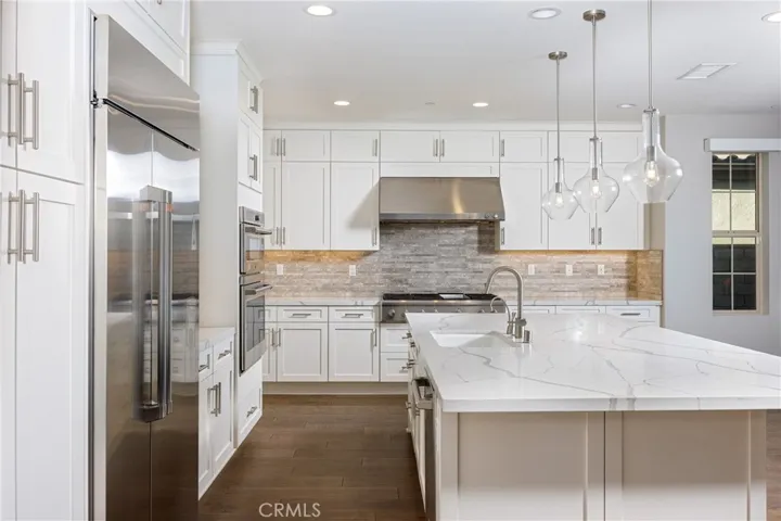 Kitchen showing upgraded lighting and appliances
