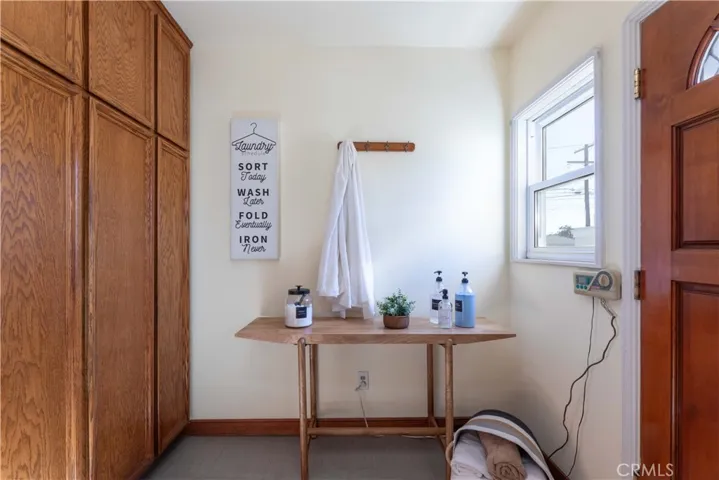 pantry area, newer water heater in closet, built in ironing board, sprinker control